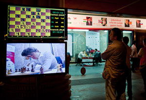 Kramnik took an early lead by defeating Carlsen seen here on screen. Photo © 