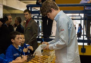 Magnus Carlsen signing autographs. Photo © Albert Silver. 