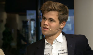 Magnus Carlsen discusses his round 2 draw against Kramnik. Photo © 