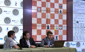 Carlsen demonstrates his Round 1 win. Photo © 