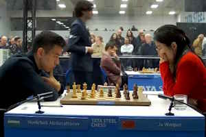 Nodirbek Abdusattorov beat Ju Wenjun to lead alone after 11 rounds. Photo © 