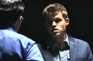 Carlsen listens to Anand after winning game 11. Photo © 