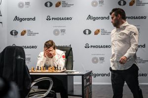 Carlsen deep in thought as Neponiachtchi looks on. Photo © 