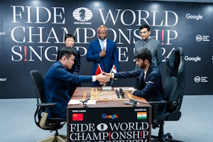 Gukesh and Ding at the start of game 4 in front of Xie Jun and Viswanathan Anand. Photo © FIDE taken from their press release.