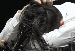 Ian Nepomniachtchi - head slumped at the board after first time control. Caruana ignored him and went to the far side of the stage. Photo © 