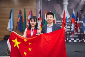 Ju Wenjun and GM Yu Shaoteng celebrate her win with the Chinese flag. Photo ©: Press Service of the Championship